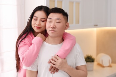 Photo of Portrait of lovely young couple in kitchen