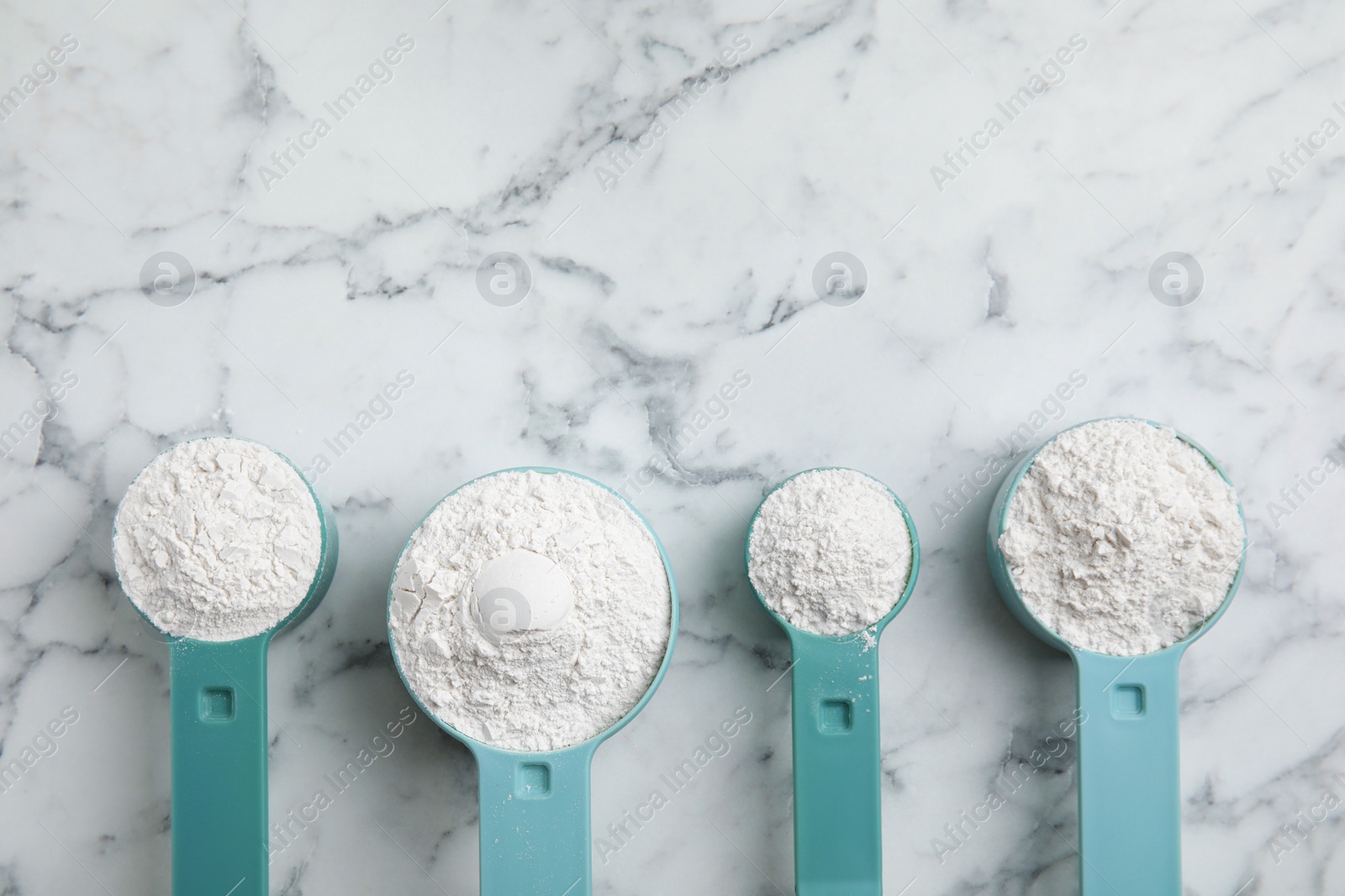 Photo of Amino acid powder on white marble table, flat lay. Space for text