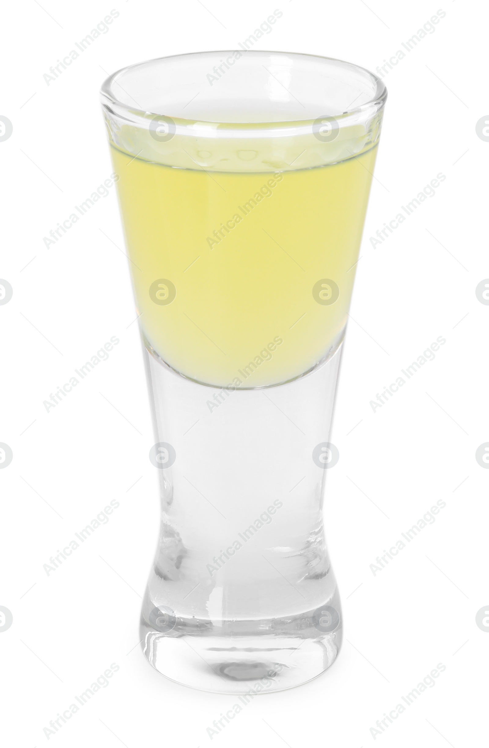 Photo of Shot glass with tasty limoncello liqueur isolated on white