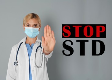 Image of STD prevention. Doctor in protective mask showing stop gesture on grey background