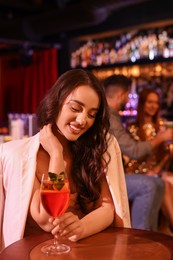 Photo of Beautiful woman with fresh alcoholic cocktail in bar