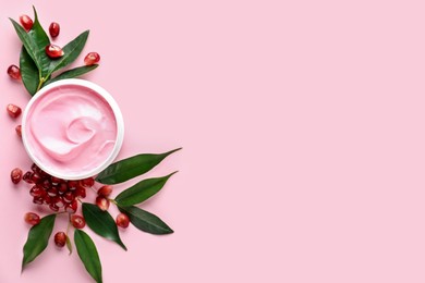 Fresh pomegranate and jar of facial mask on pink background, flat lay. Space for text