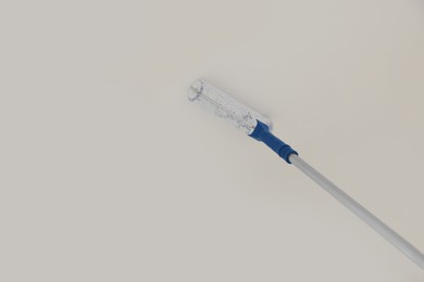 Painting ceiling with white dye indoors, low angle view