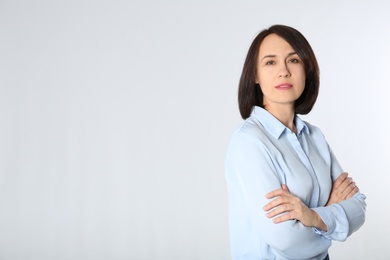 Photo of Portrait of mature businesswoman on white background. Space for text