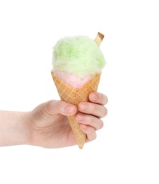 Photo of Woman holding waffle cone with cotton candy on white background, closeup