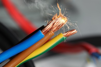 Image of Sparking wiring on blurred background, closeup view