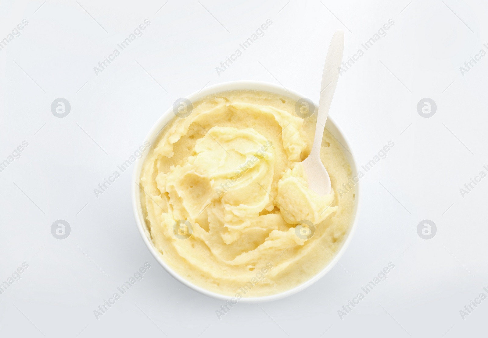 Photo of Bowl with tasty mashed potatoes on white background, top view