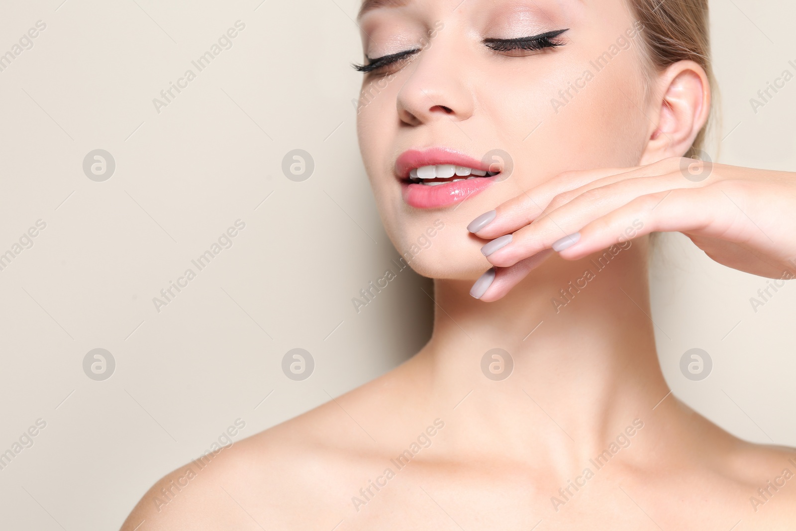 Photo of Beautiful young woman with perfect lips makeup on light background, closeup