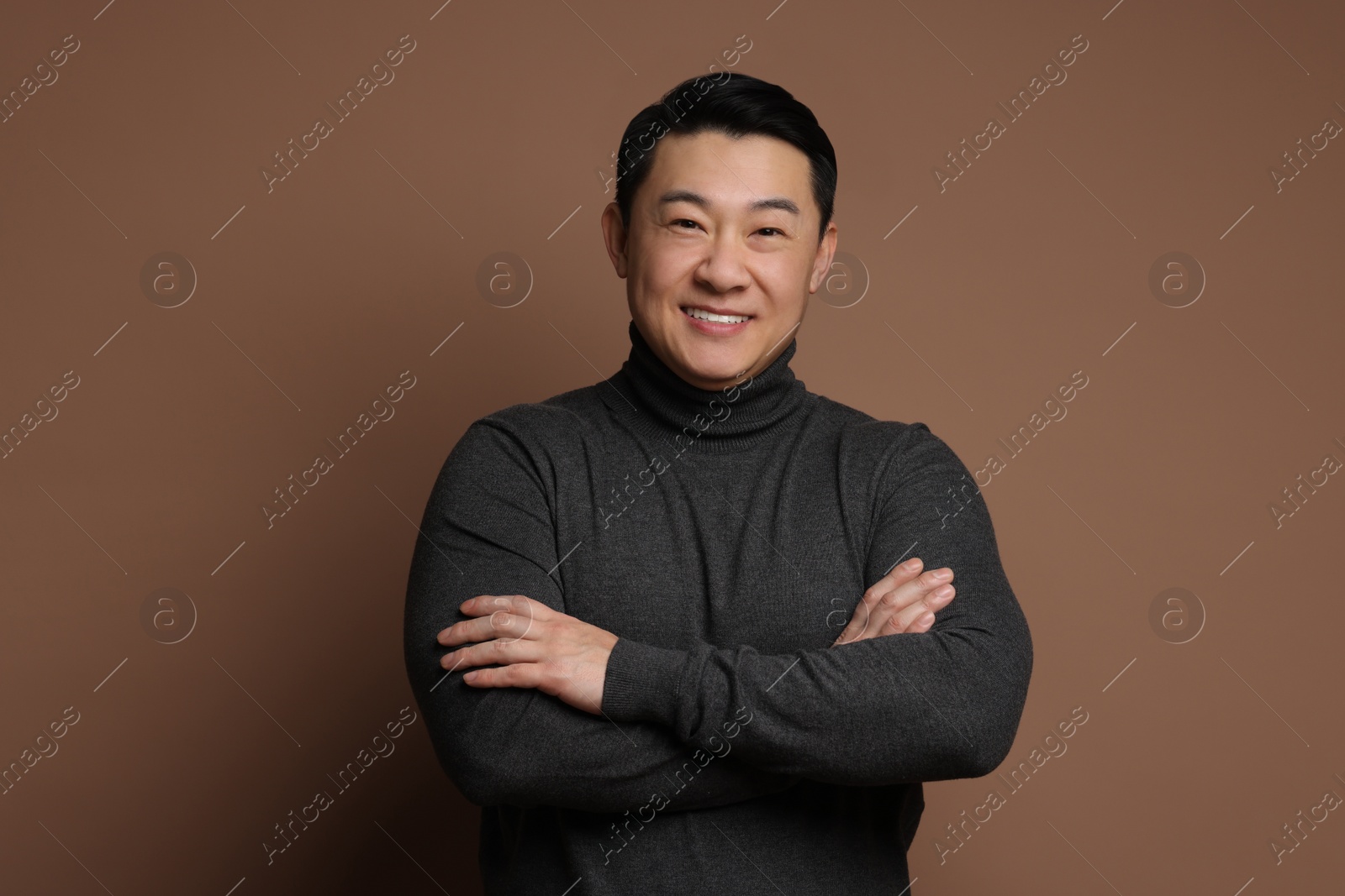 Photo of Portrait of happy man on brown background