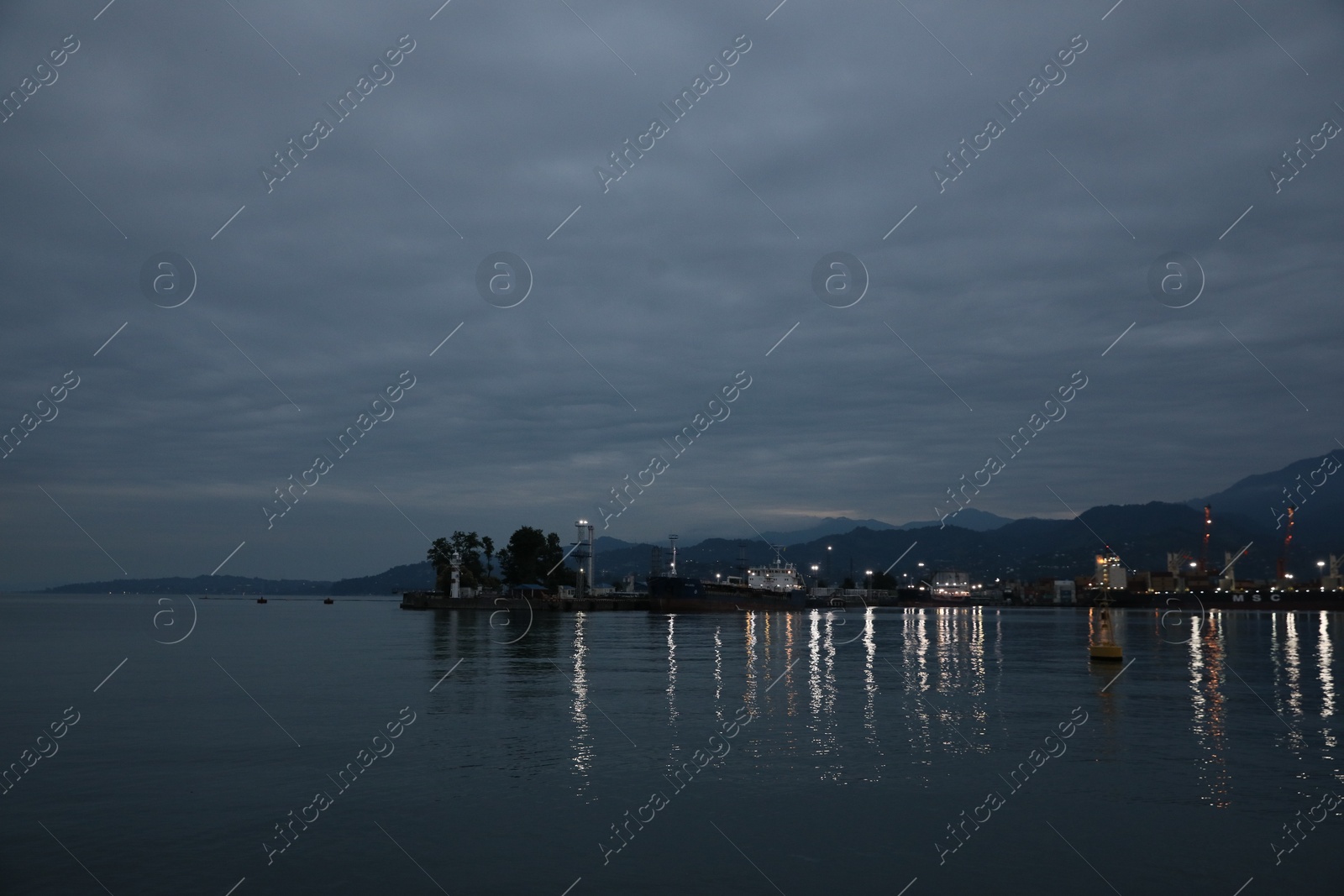 Photo of Port under dark cloudy sky in evening