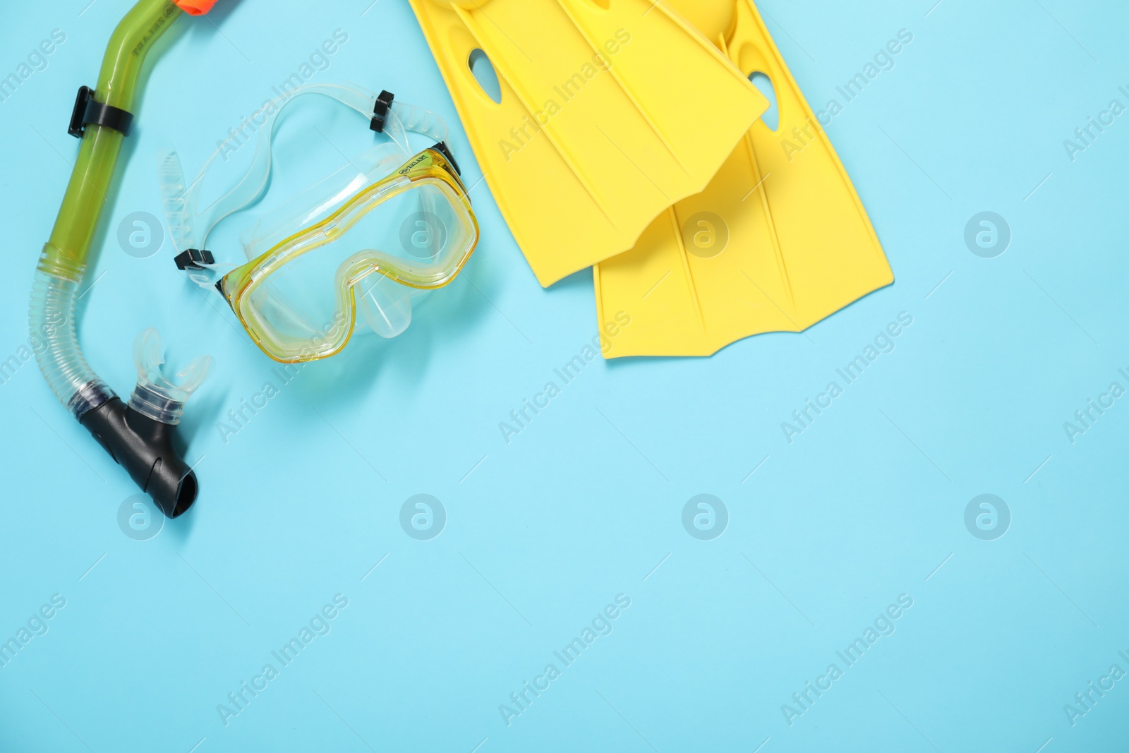 Photo of Different sports equipment on light blue background, flat lay. Space for text