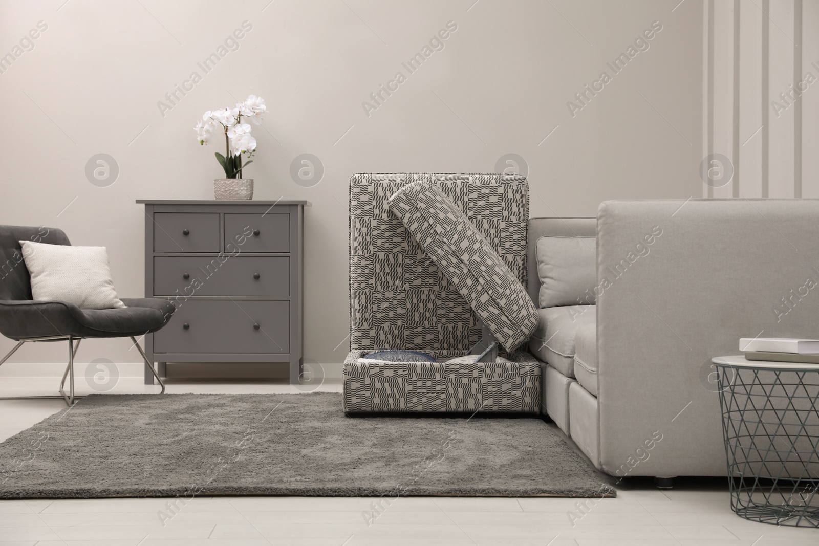 Photo of Modular sofa in living room, open section with storage. Interior design