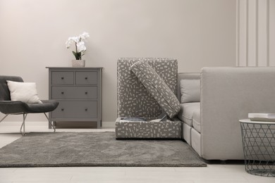Modular sofa in living room, open section with storage. Interior design