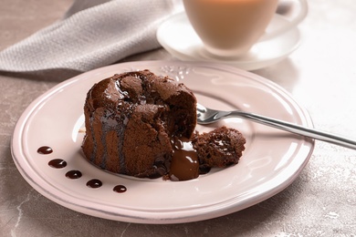 Photo of Plate of delicious fresh fondant with hot chocolate on table. Lava cake recipe