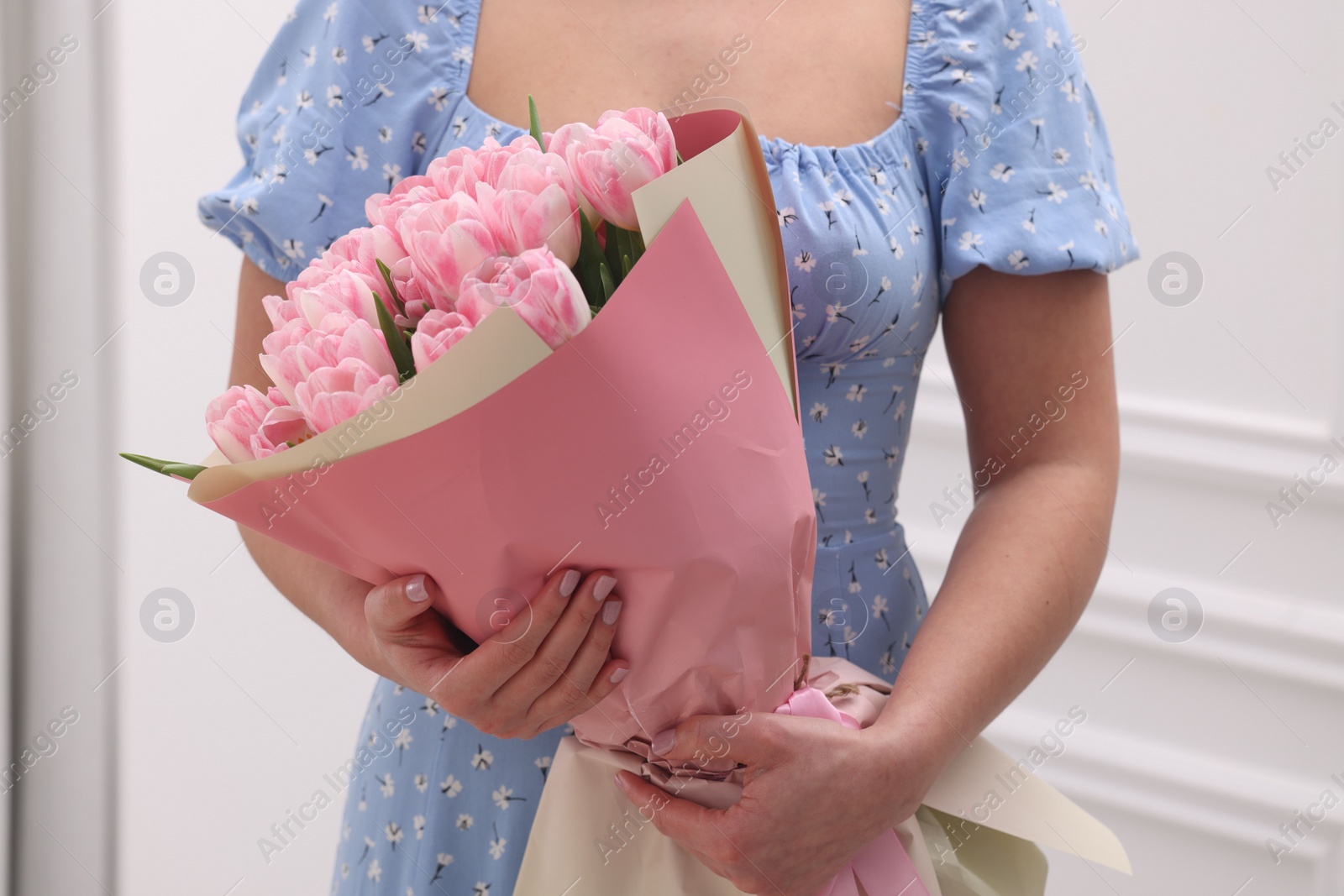 Photo of Woman with bouquet of beautiful fresh tulips on blurred background, closeup