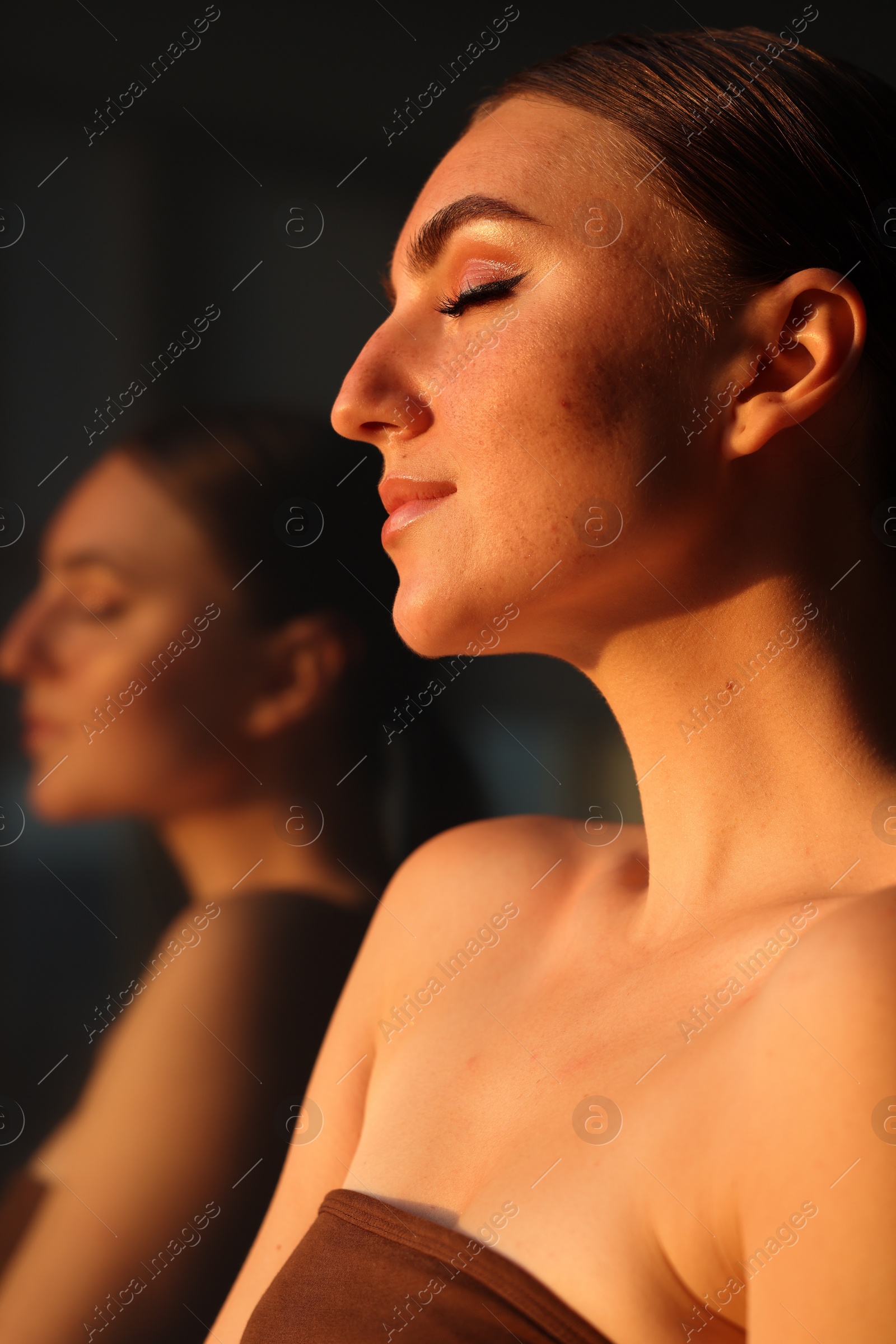 Photo of Fashionable portrait of beautiful woman with fake freckles on blurred background, closeup