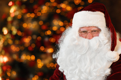 Photo of Portrait of Santa Claus on blurred background, space for text. Christmas time