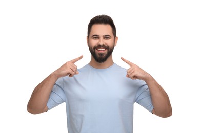 Photo of Man showing his clean teeth and smiling on white background