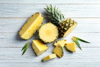 Flat lay composition with fresh sliced pineapple on wooden background