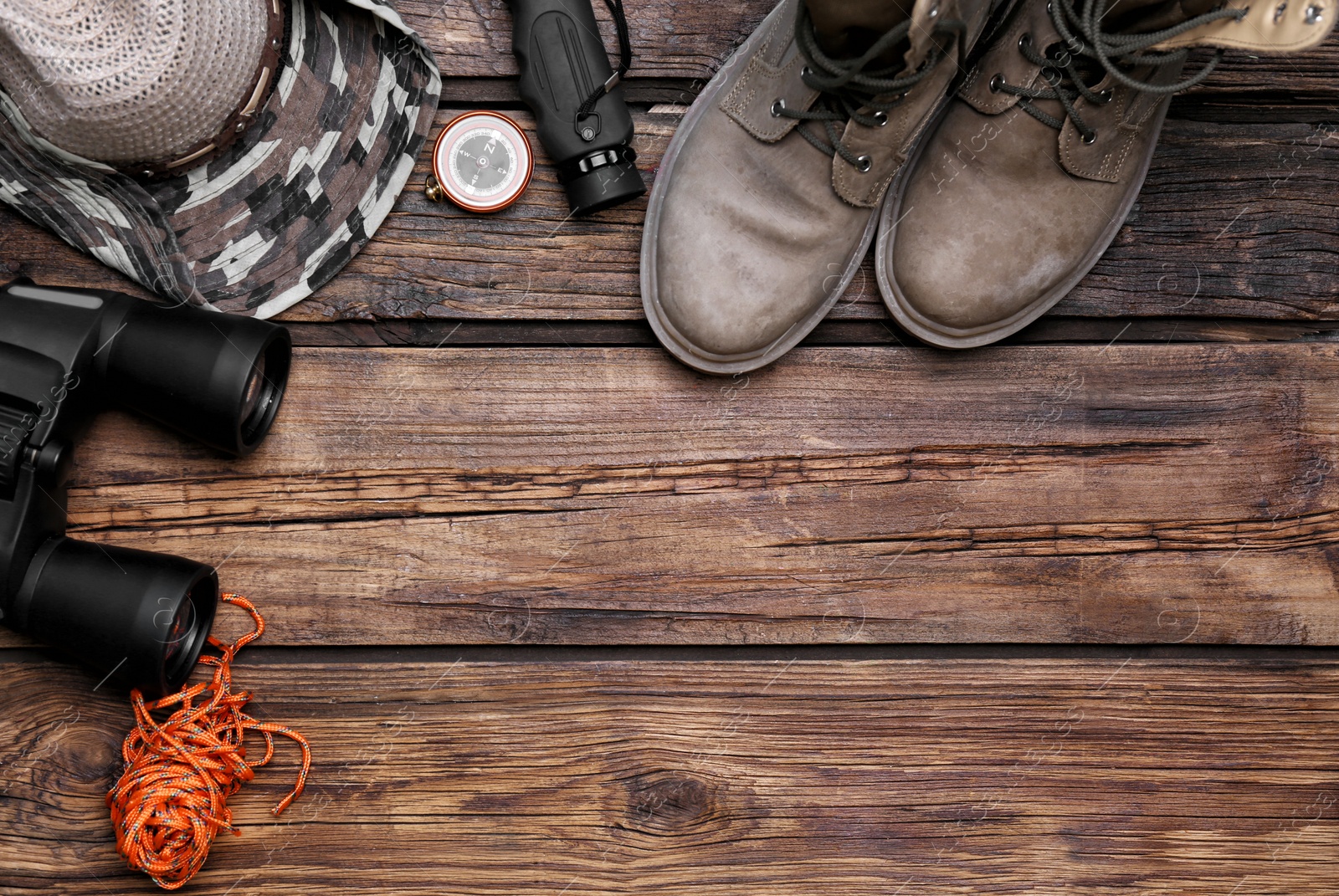 Photo of Flat lay composition with camping equipment on wooden background