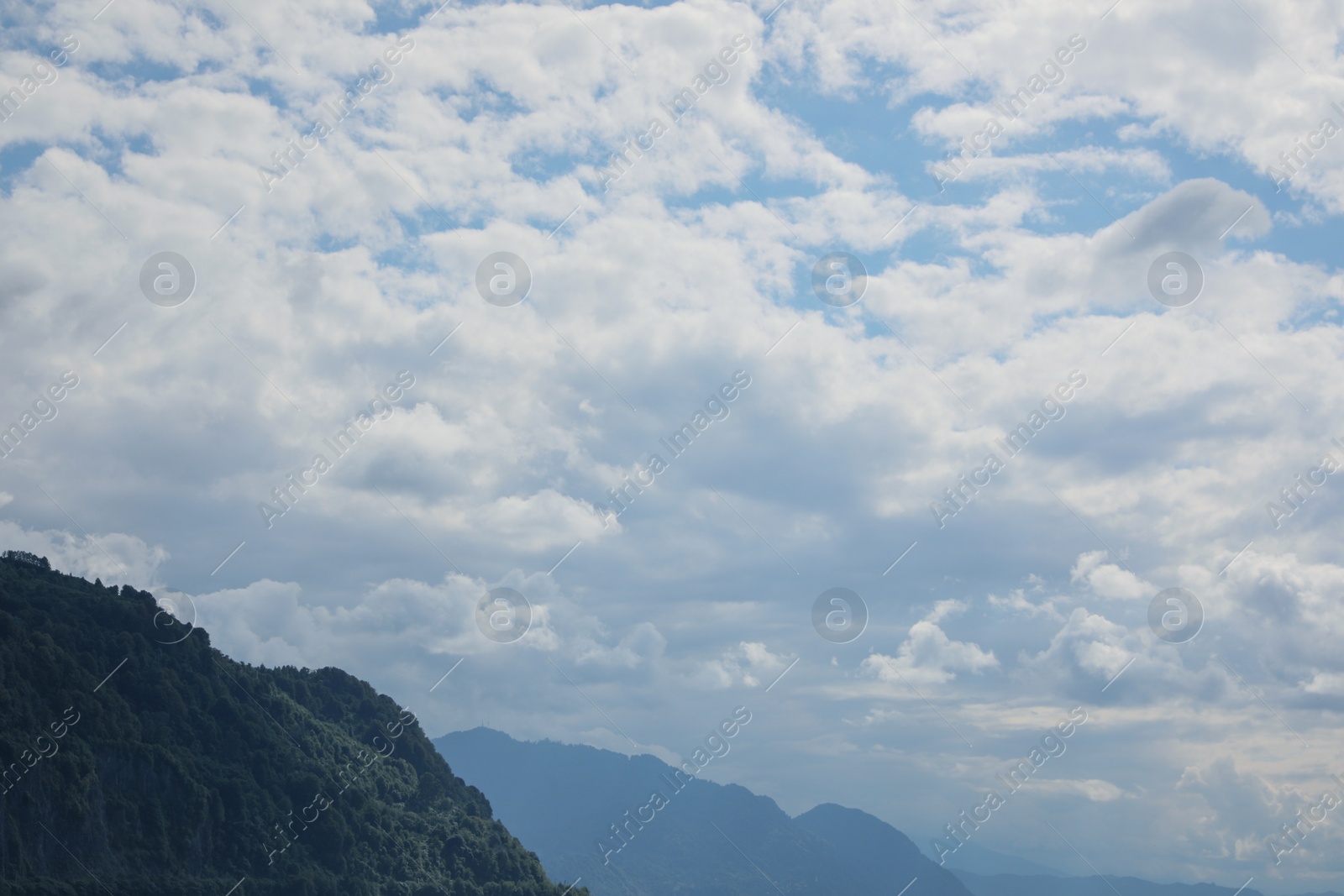 Photo of Picturesque view of mountains under beautiful sky with fluffy clouds