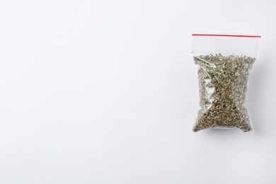 Photo of Plastic bag with spice on white background, top view