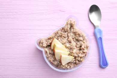 Photo of Flat lay composition with oatmeal on pink wooden table. Breakfast for kids