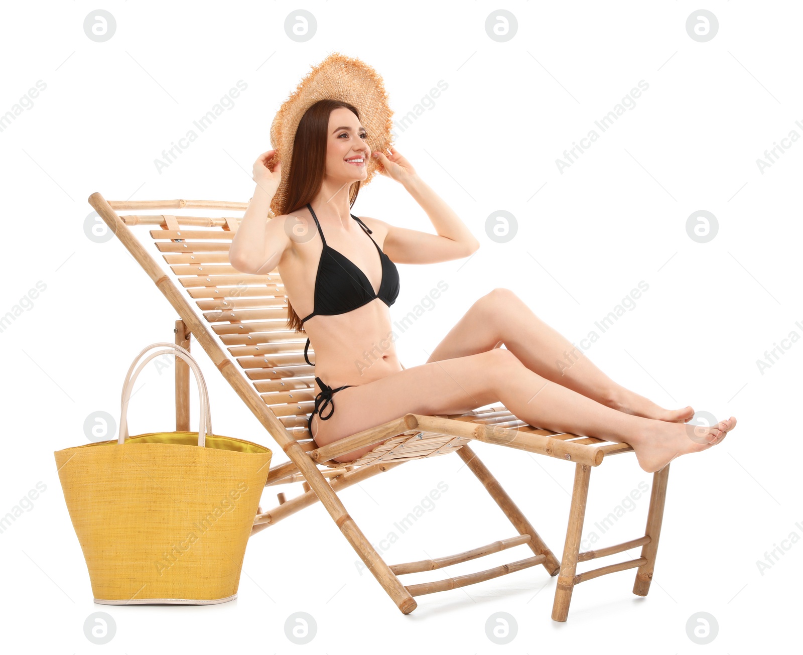 Photo of Young woman with bag on sun lounger against white background. Beach accessories