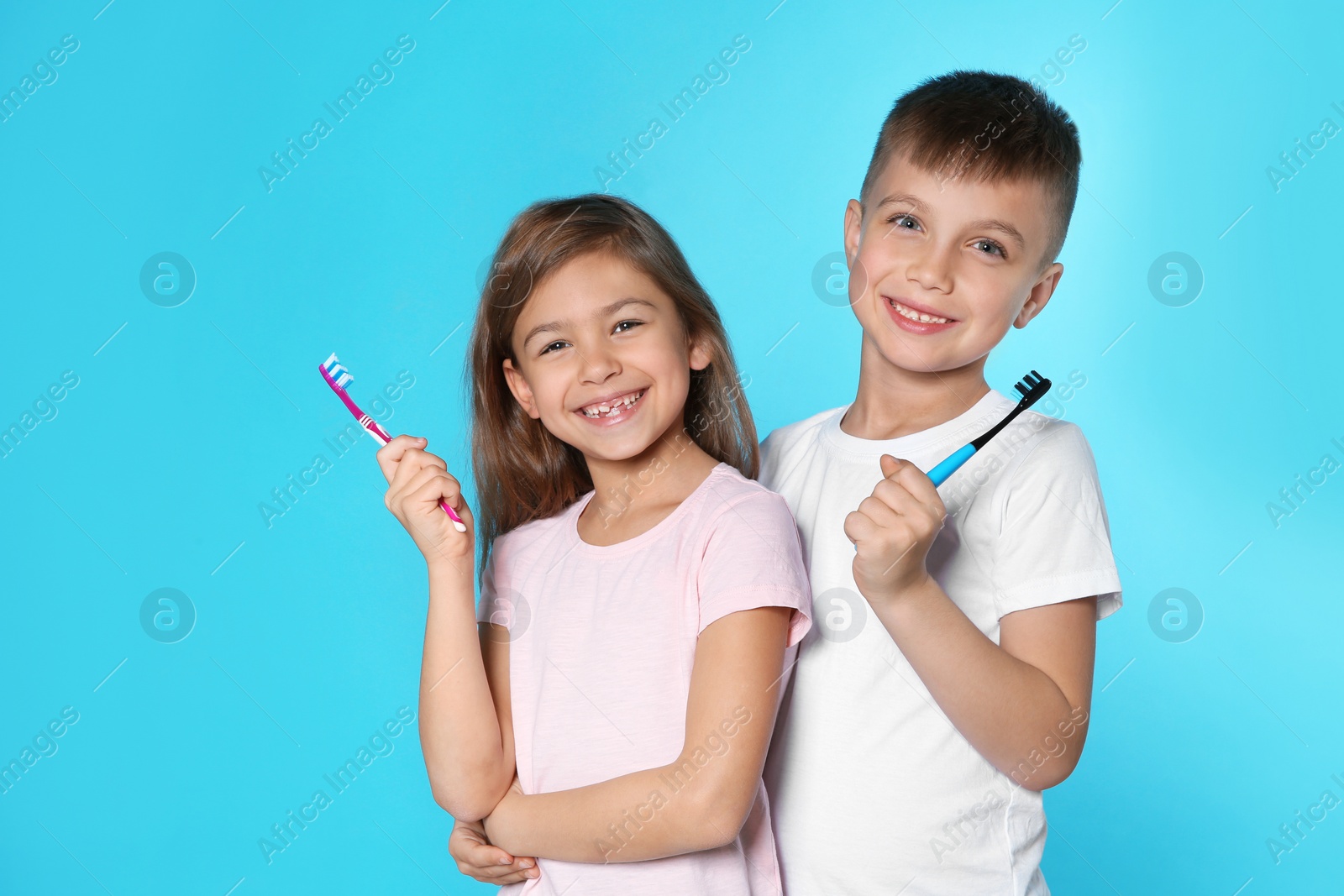 Photo of Portrait of cute children with toothbrushes on color background