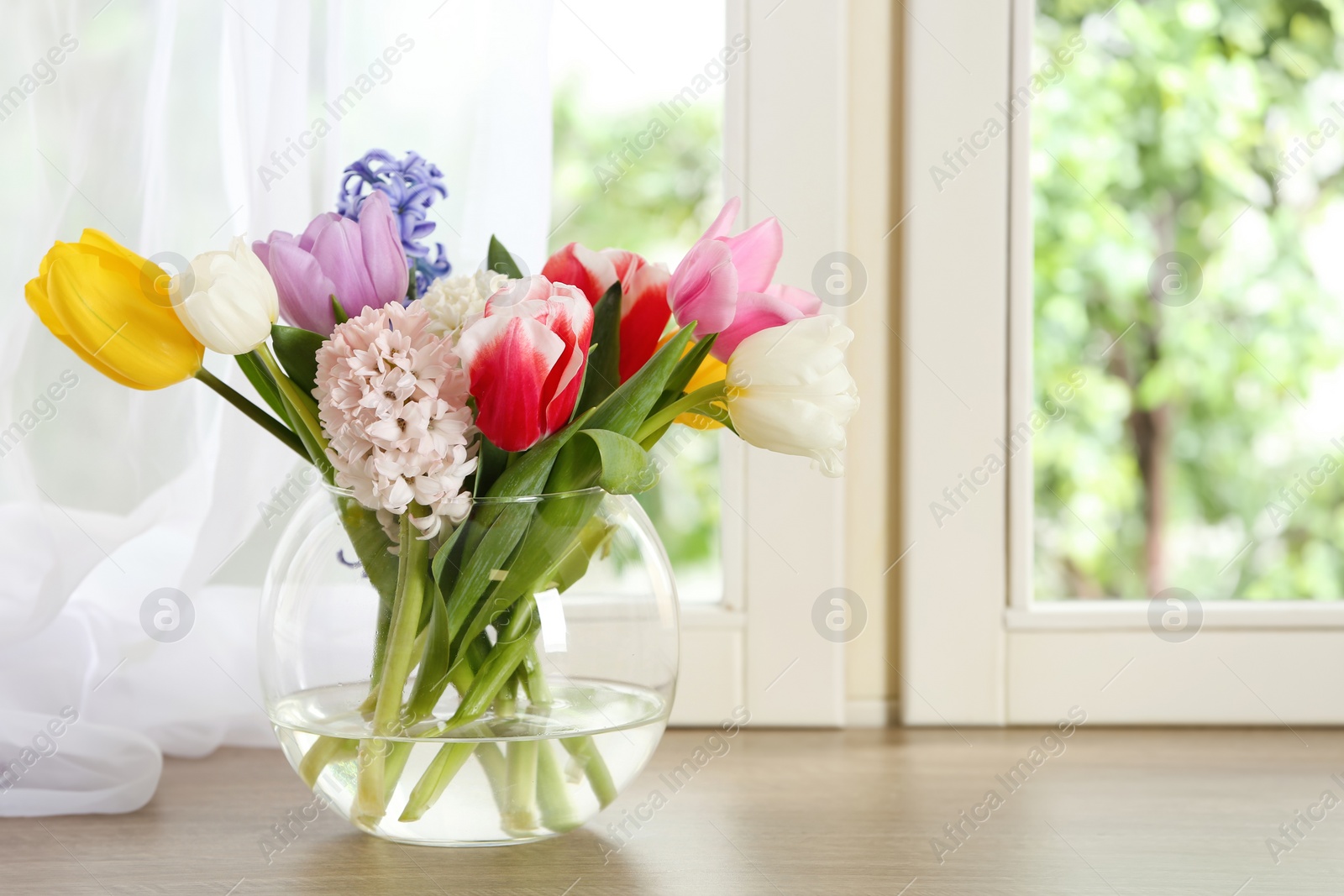 Photo of Beautiful spring flowers on window sill indoors