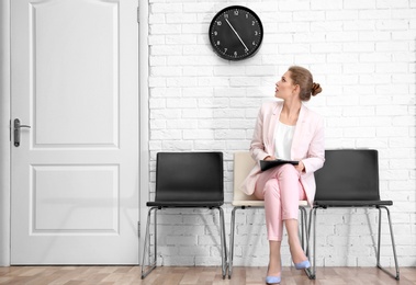 Young woman waiting for job interview, indoors