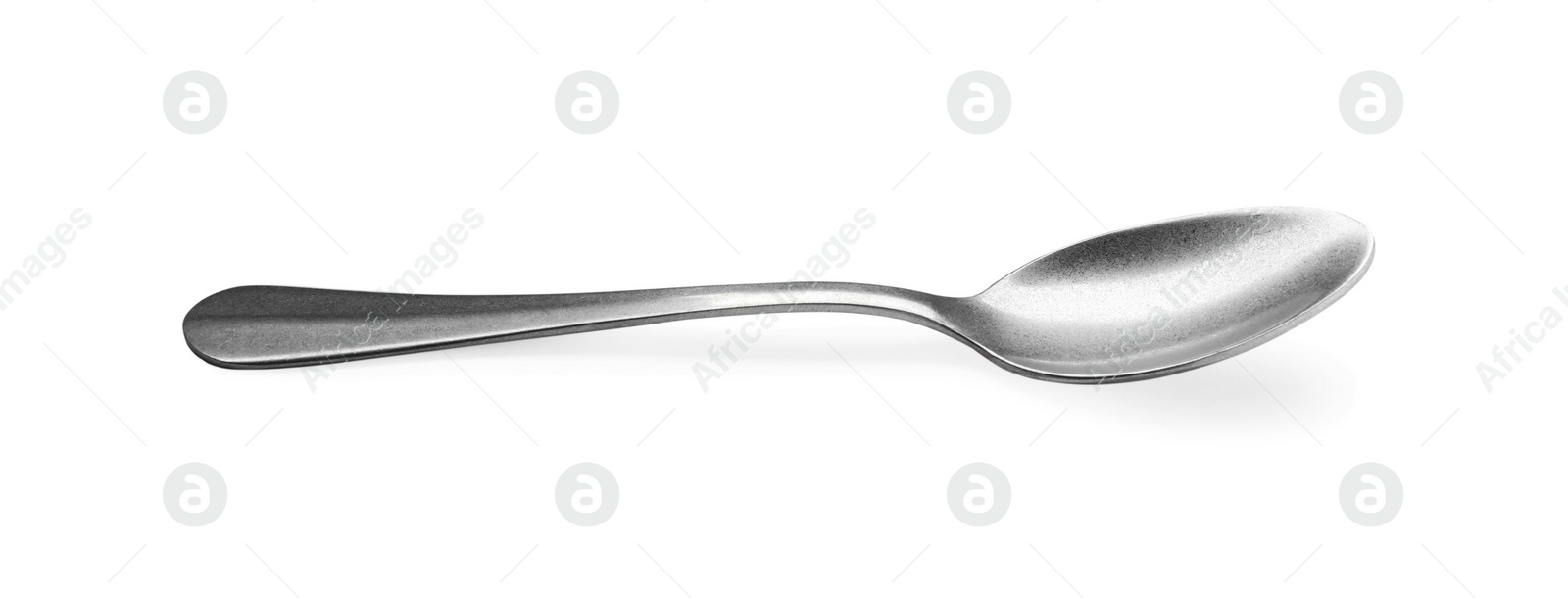 Photo of New clean shiny spoon isolated on white