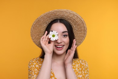 Photo of Beautiful woman with spring flower in hand on yellow background