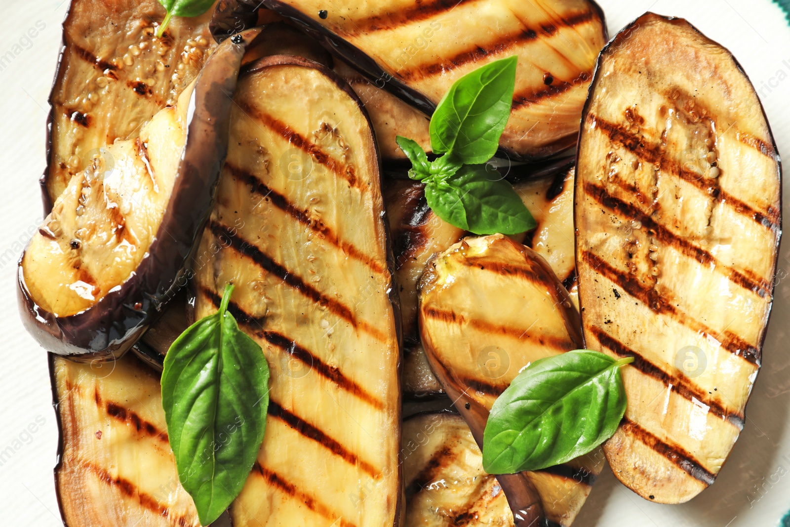 Photo of Plate with tasty fried eggplant slices, closeup