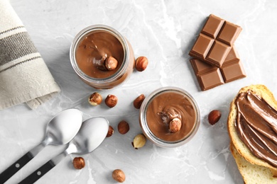 Photo of Sweet chocolate mousse served on marble table, flat lay