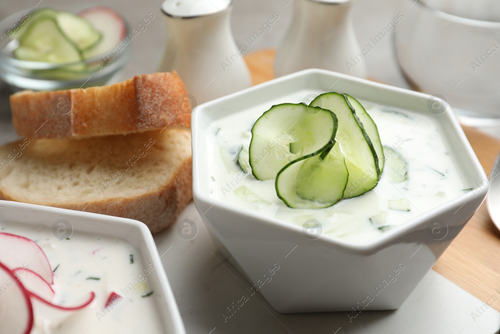 Photo of Delicious cold summer soup in bowl on table, closeup