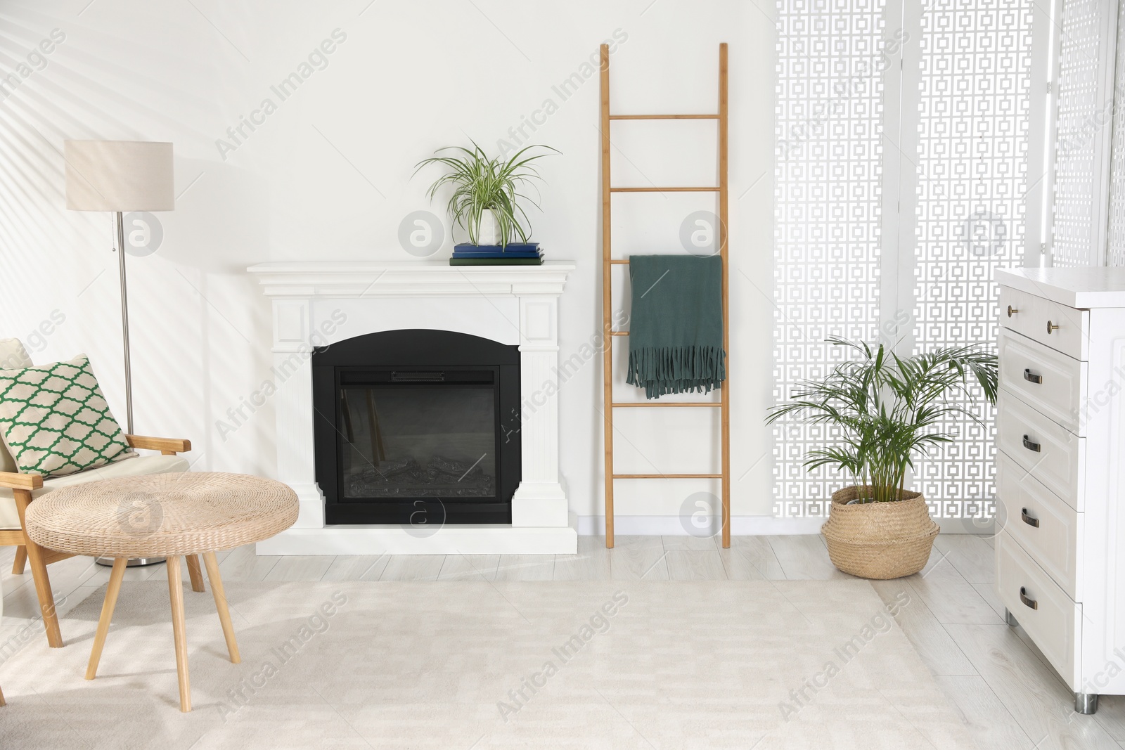 Photo of Wooden ladder near fireplace in stylish room