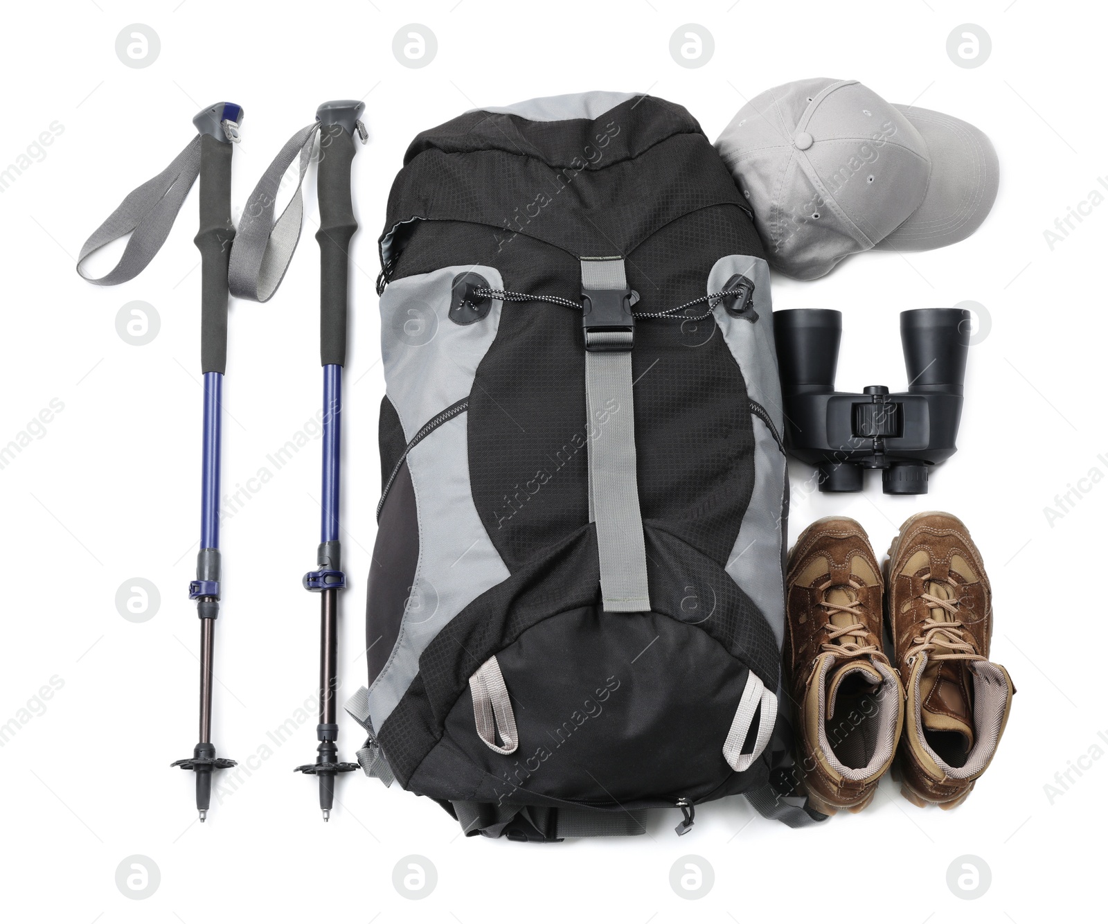 Photo of Pair of trekking poles and camping equipment for tourism on white background, top view