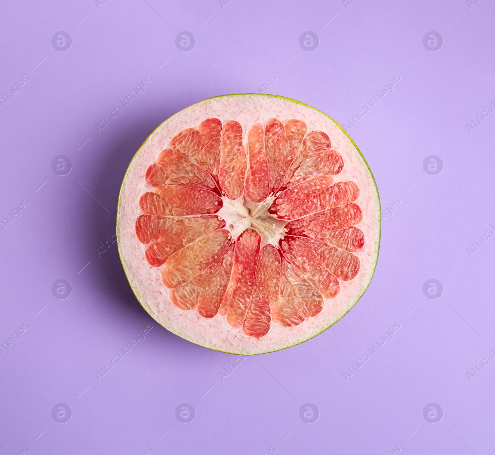 Photo of Fresh cut pomelo fruit on lilac background, top view