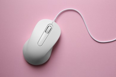 Photo of One wired mouse on pink background, top view