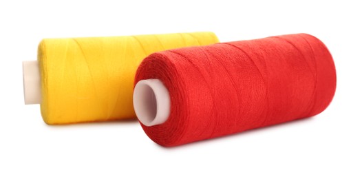 Photo of Different colorful sewing threads on white background, closeup