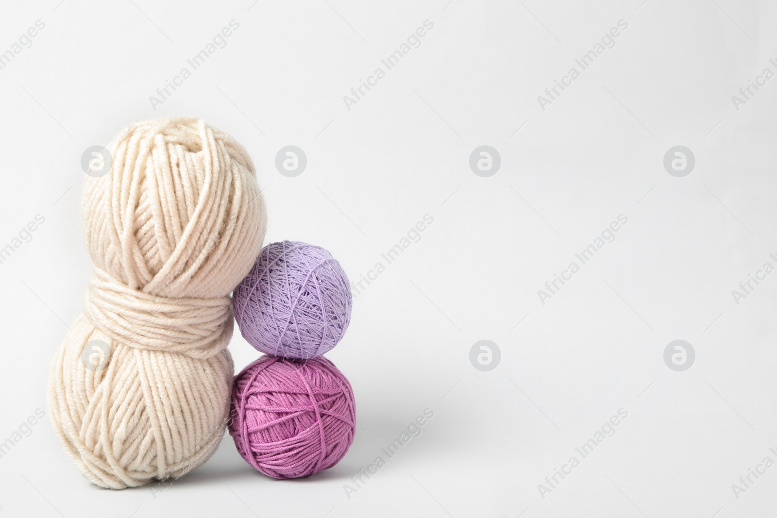 Photo of Soft colorful woolen yarns on white background