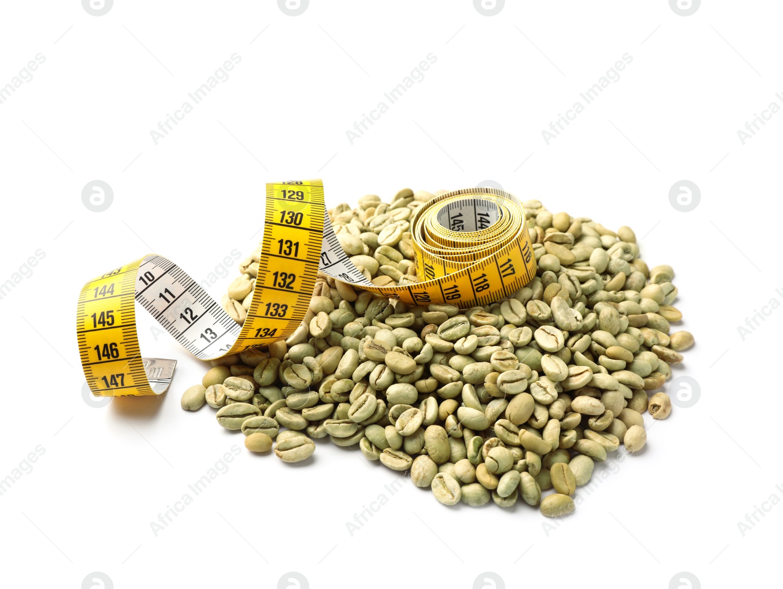 Photo of Pile of green coffee beans and measuring tape on white background