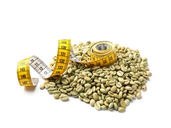 Photo of Pile of green coffee beans and measuring tape on white background