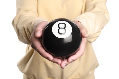 Woman holding magic eight ball on white background, closeup