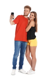 Photo of Happy young couple taking selfie on white background