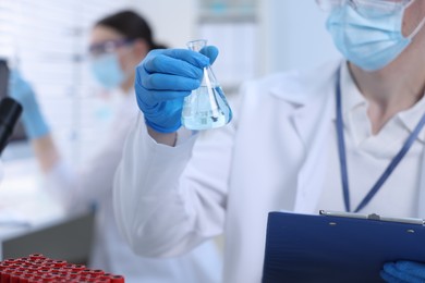 Photo of Scientists working with samples in laboratory, closeup. Medical research