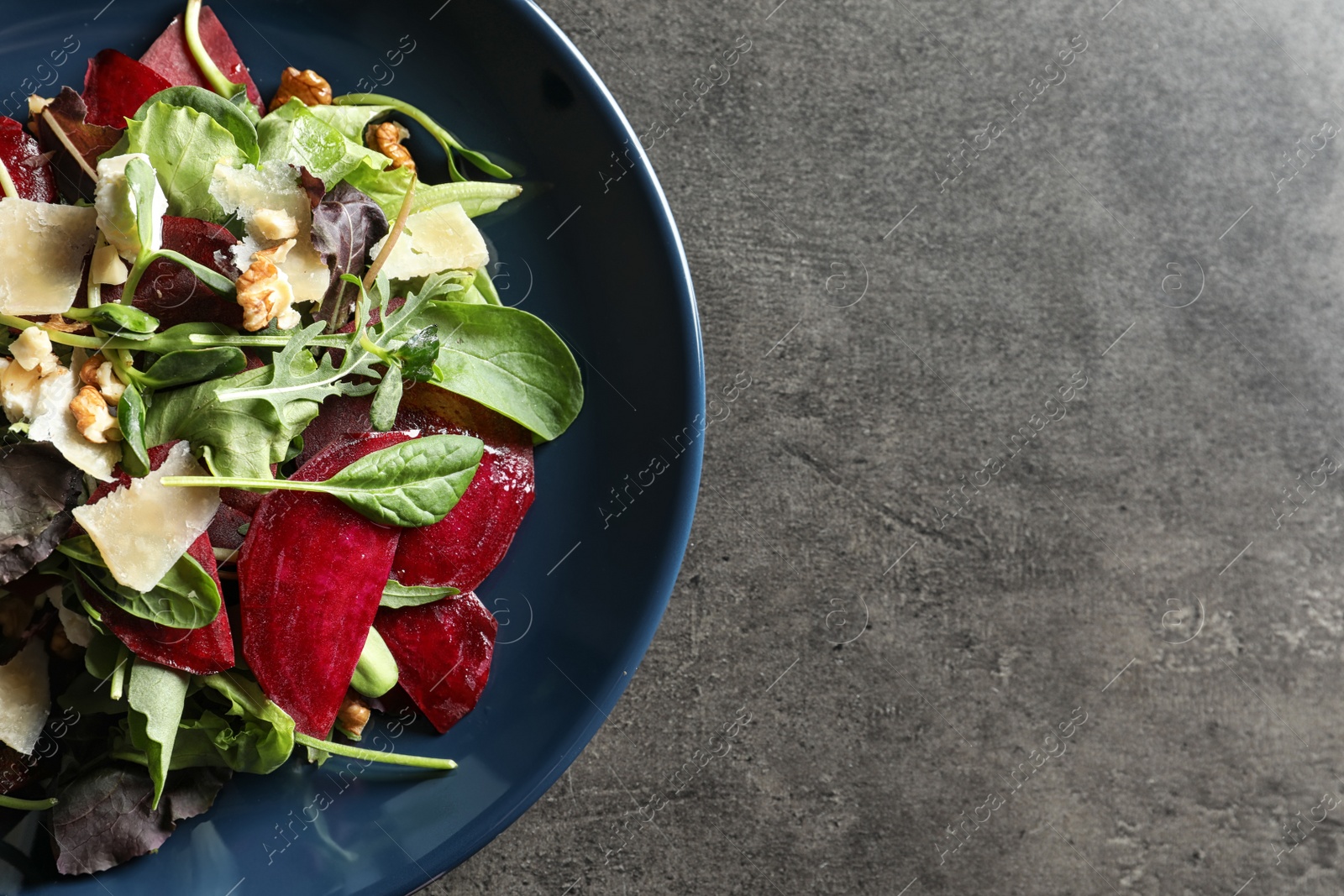 Photo of Plate with delicious beet salad on grey background, top view