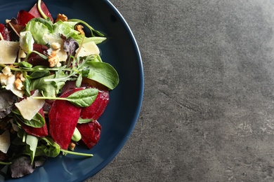 Plate with delicious beet salad on grey background, top view