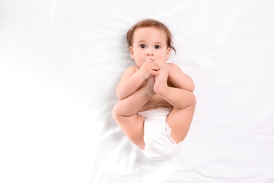 Cute little baby lying on white background, top view